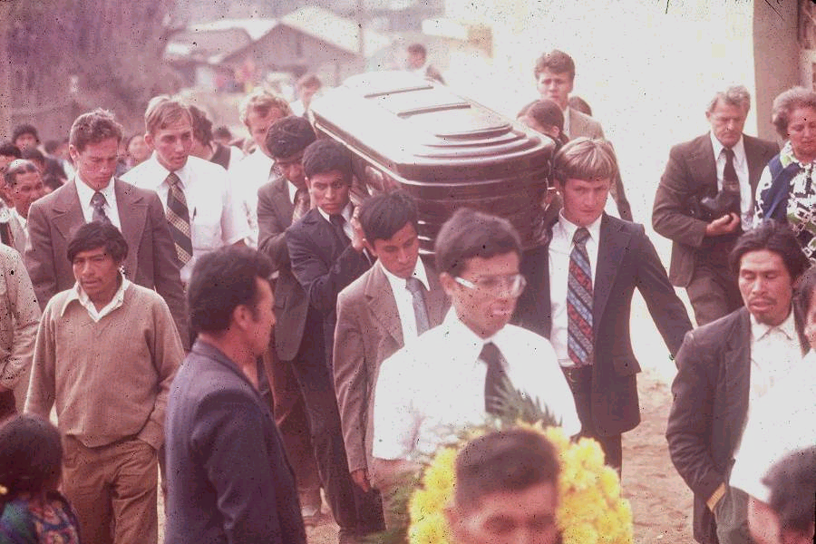 Carrying Daniel Choc's coffin to the cemetery. Missionaries pictured (from left to right): Elders Bernhardt, Frischknecht, Robbins, Salazar, Fulgencio Choy, and Elder Howard (front right of coffin).