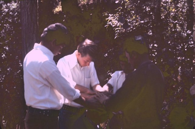 Elder Richman confirming Ricardo Cua a member of the Church on the banks of the river Balanyá on February 12, 1976